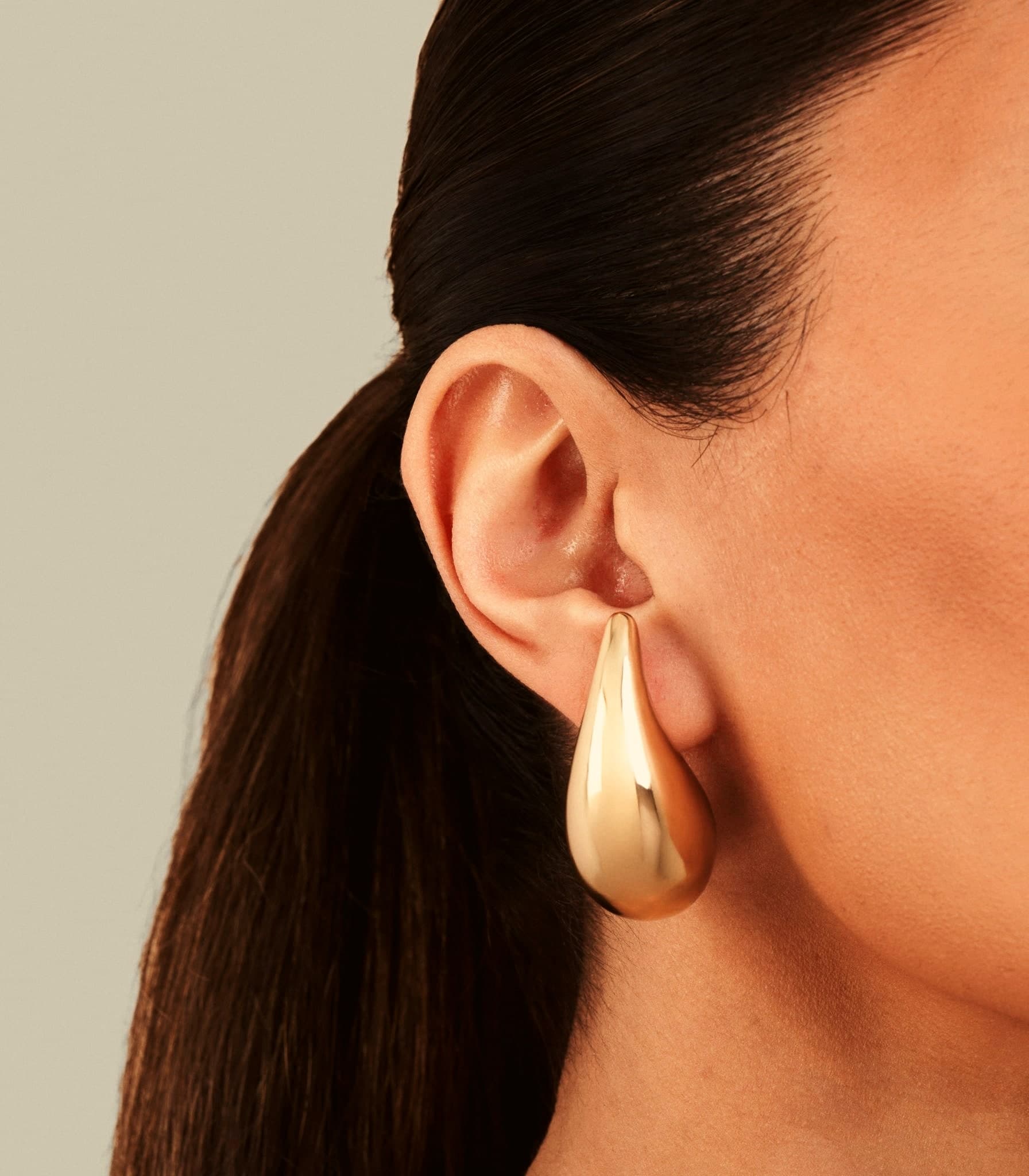 Model wearing the 18ct Gold Sculptural Teardrop Statement Earrings